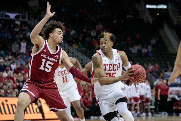Mar 11, 2022; Kansas City, MO, USA; Texas Tech Red Raiders guard Adonis Arms (25) drives to the basket around Oklahoma Sooners forward Ethan Chargois (15) during the second half at T-Mobile Center.
